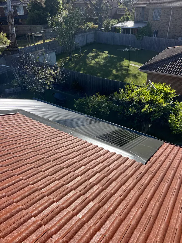 BM Roof Plumbing installing metal roofing on a home extension